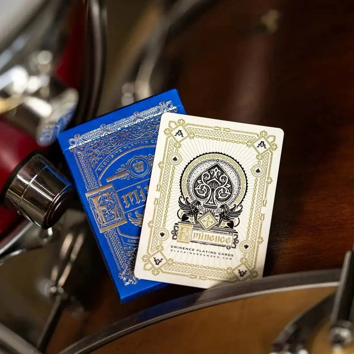 Eminence Blue Topaz playing cards in blue and gold packaging, stylishly displayed on a wooden surface
