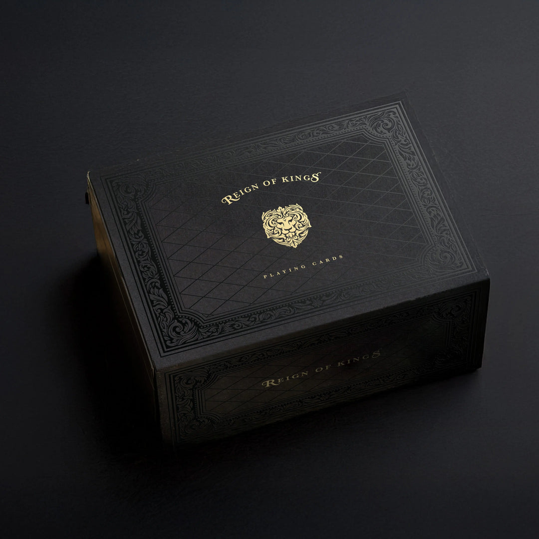 Black leather box with gold embossed logo on a dark background