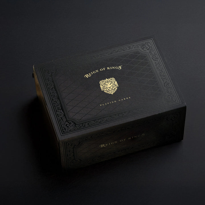 Black leather box with gold embossed logo on a dark background