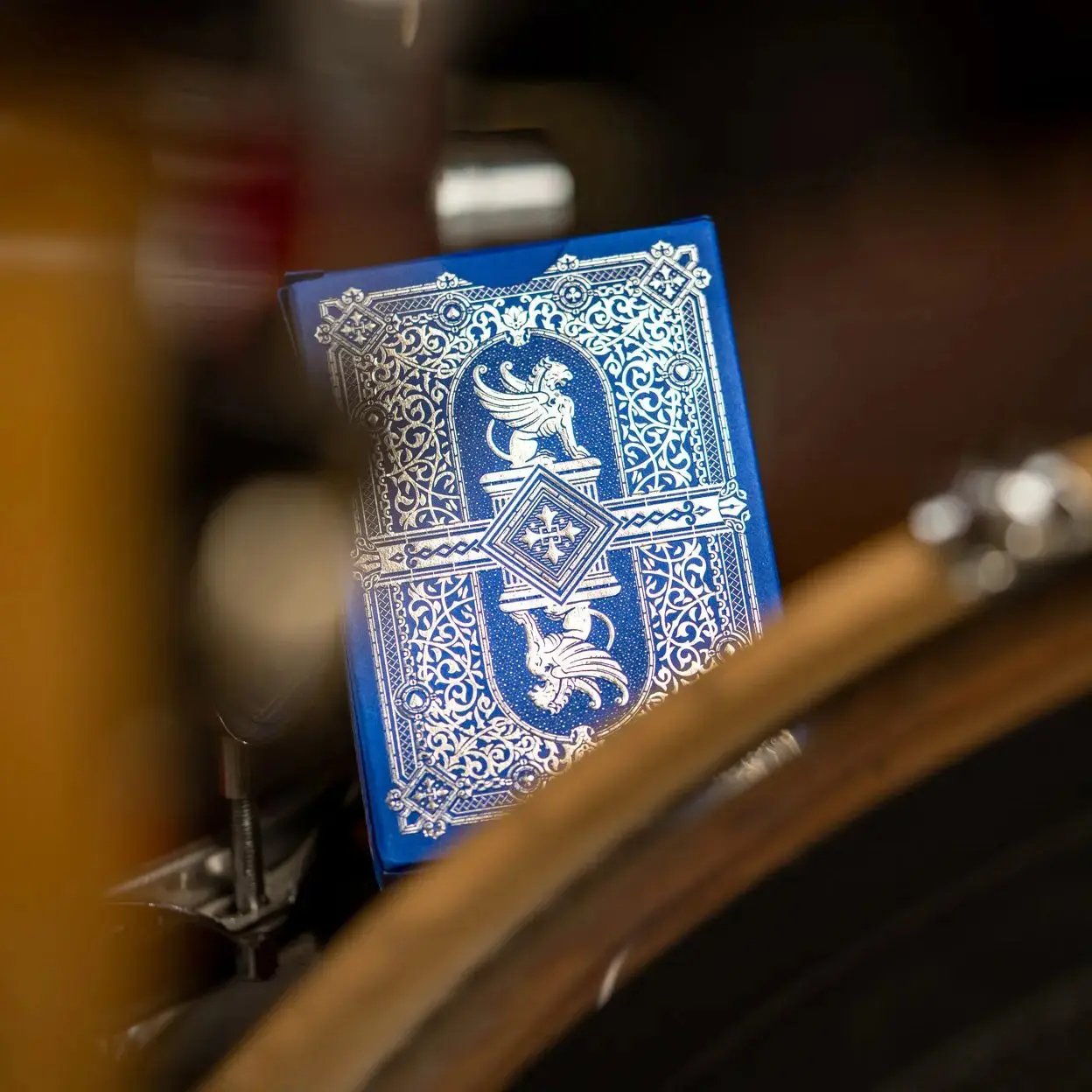 Eminence Blue Topaz playing cards in an ornate blue design displayed on a wooden table