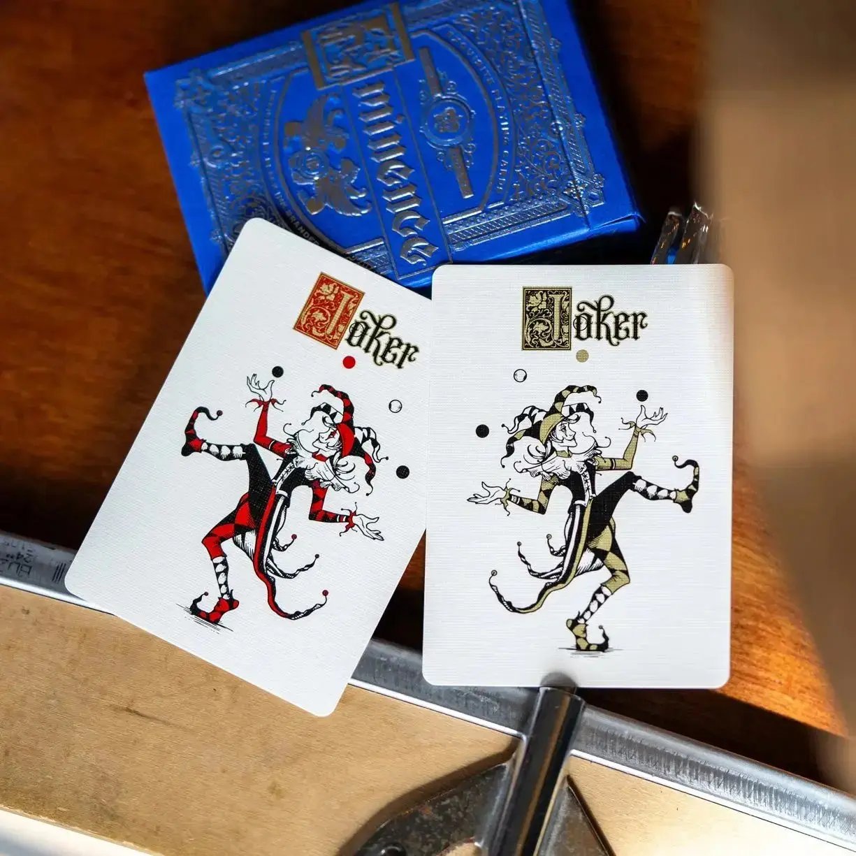 Eminence Blue Topaz playing cards featuring unique Joker designs in red and gold
