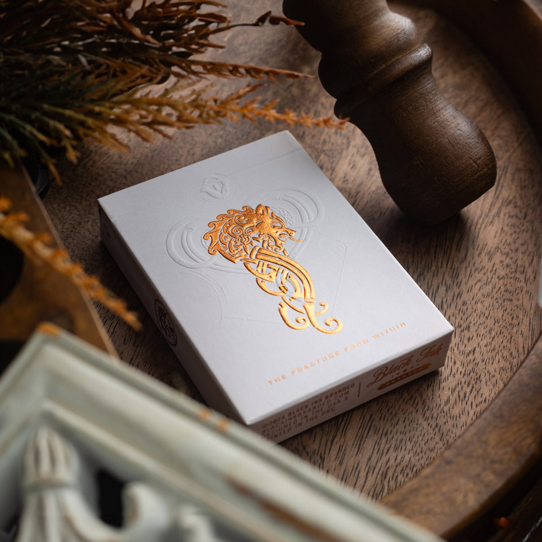 Luminosity LUX Edition cards in elegant white box with gold foil design on wooden table