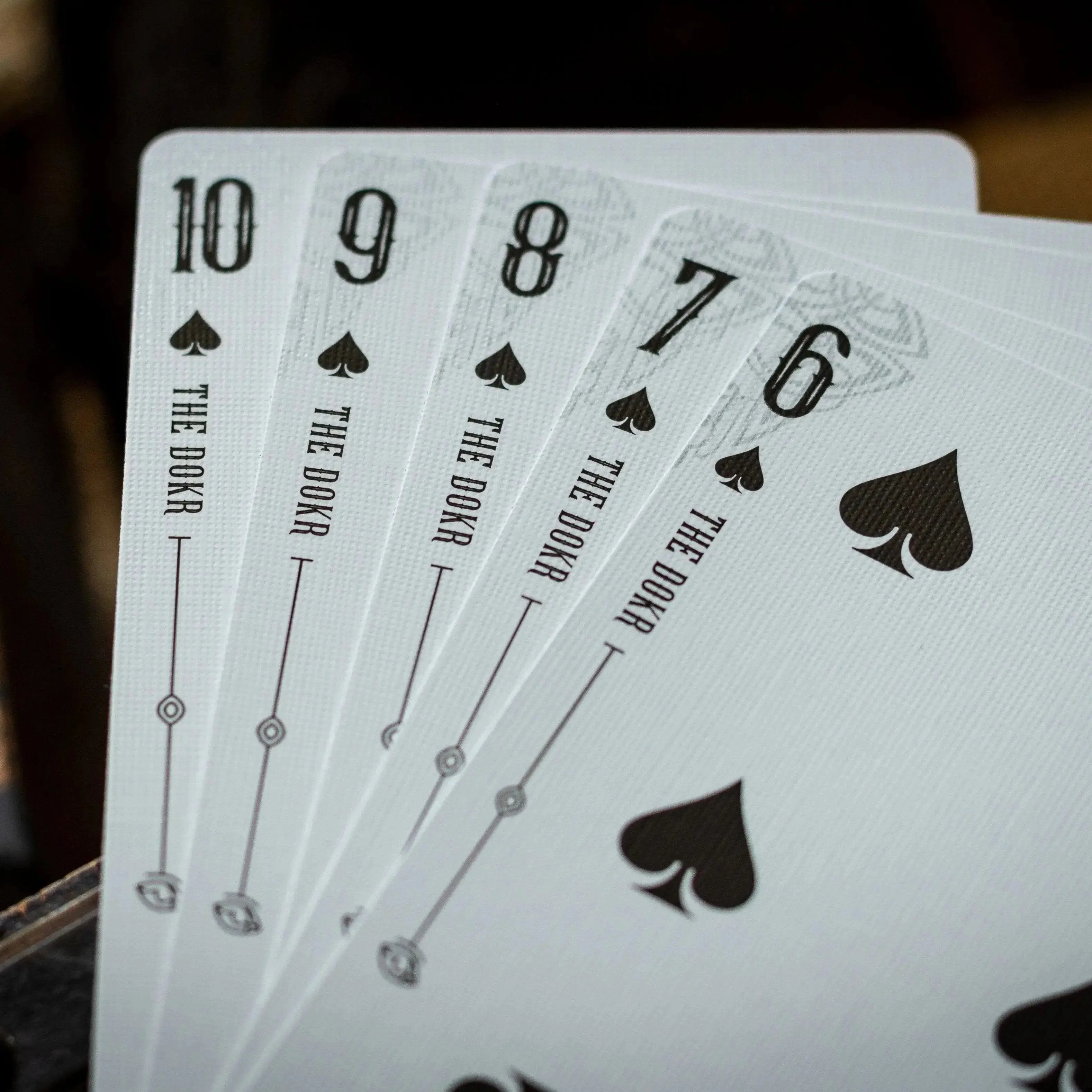 Luminosity LUX Gilded Edition deck of playing cards displaying numbered spade cards 10 to 7