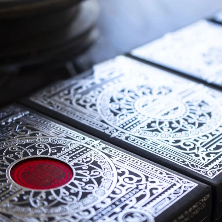 The Vault Devastation Silver Edition playing cards with intricate foil designs and vibrant detailing