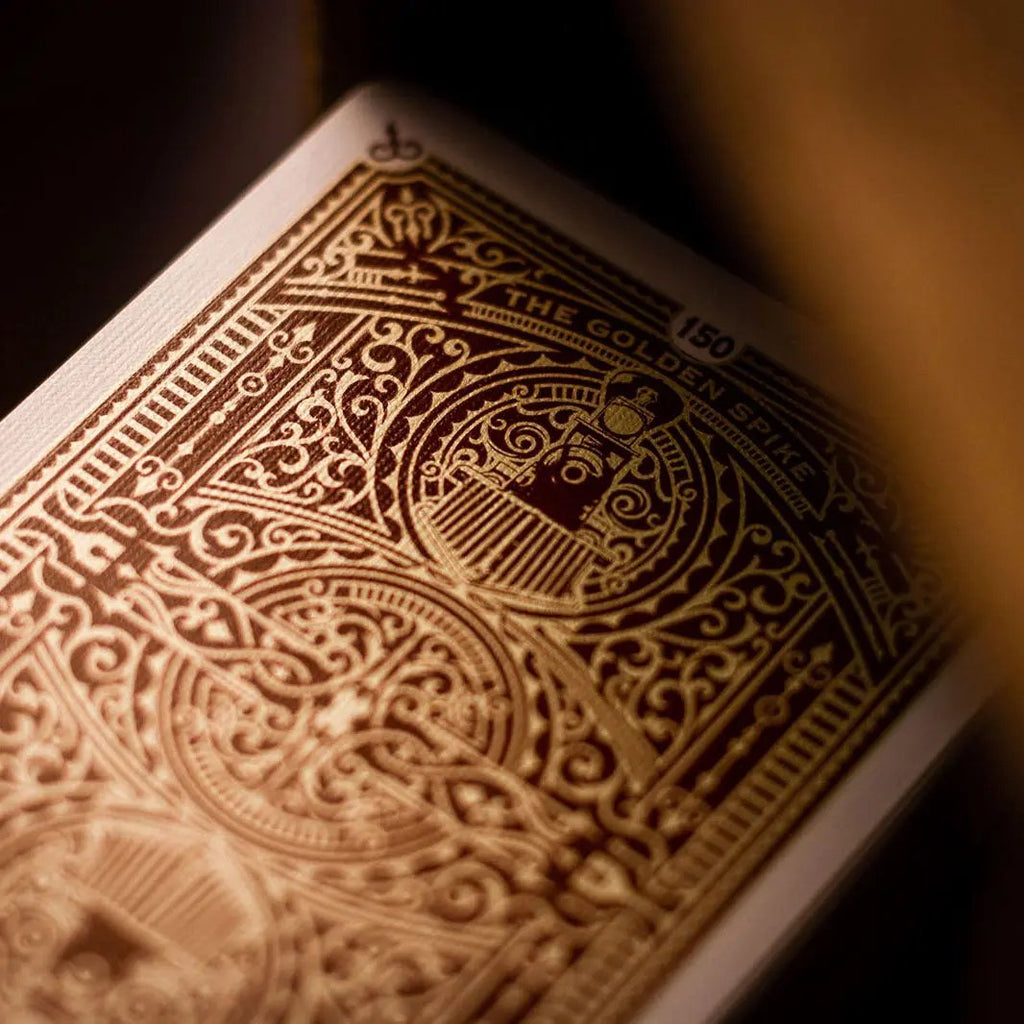 Golden Spike 150th Anniversary playing cards featuring intricate gold design and historic illustration