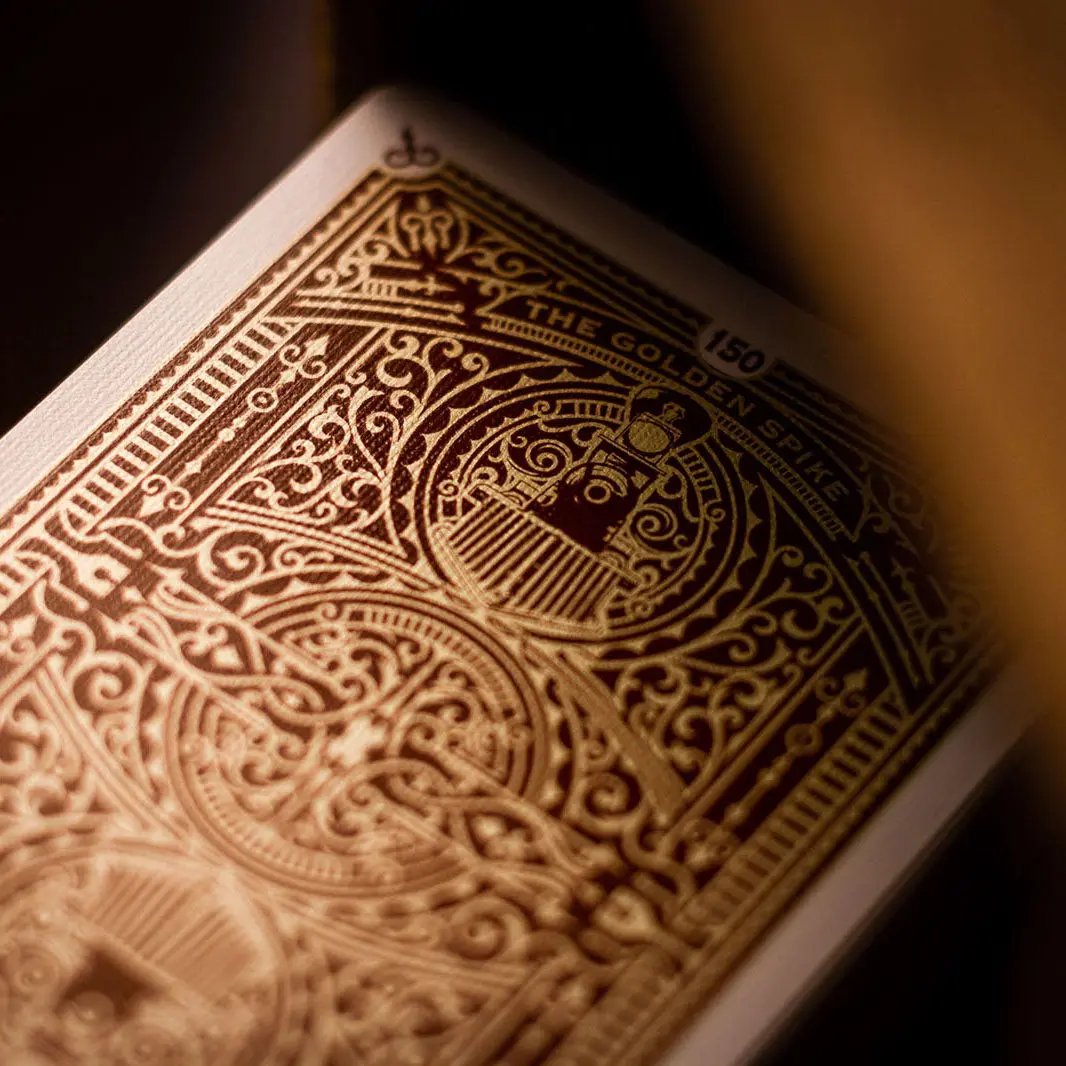 Golden Spike 150th Anniversary playing cards featuring intricate gold design and historic illustration