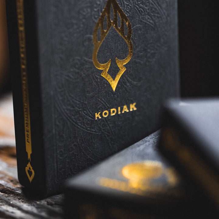 Kodiak 2020 edition playing cards with elegant black and gold design on a textured background