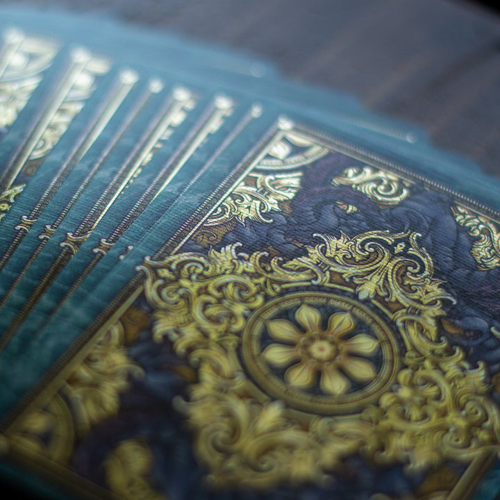 Kraken Signature playing card set featuring intricate gold and blue designs on premium cardstock