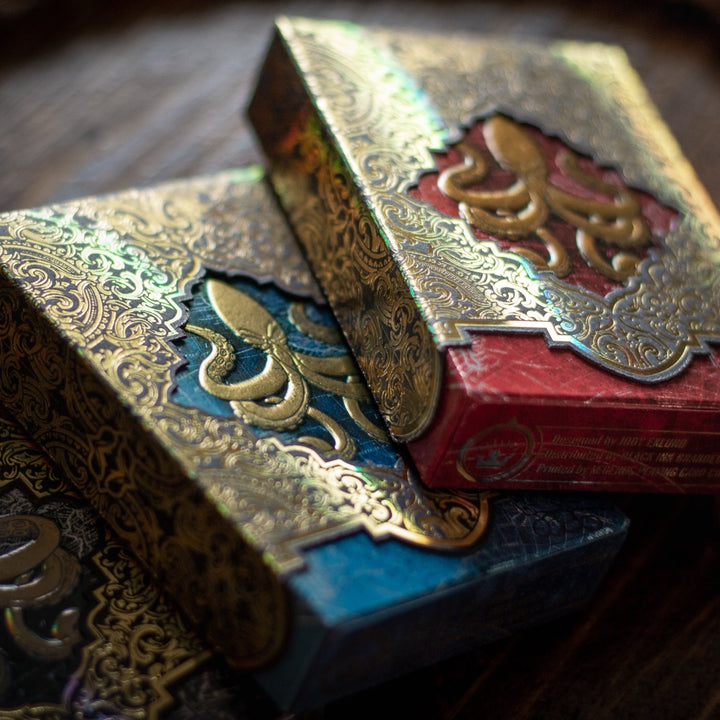 Kraken Signature playing card set featuring intricate gold and colorful designs on premium boxes