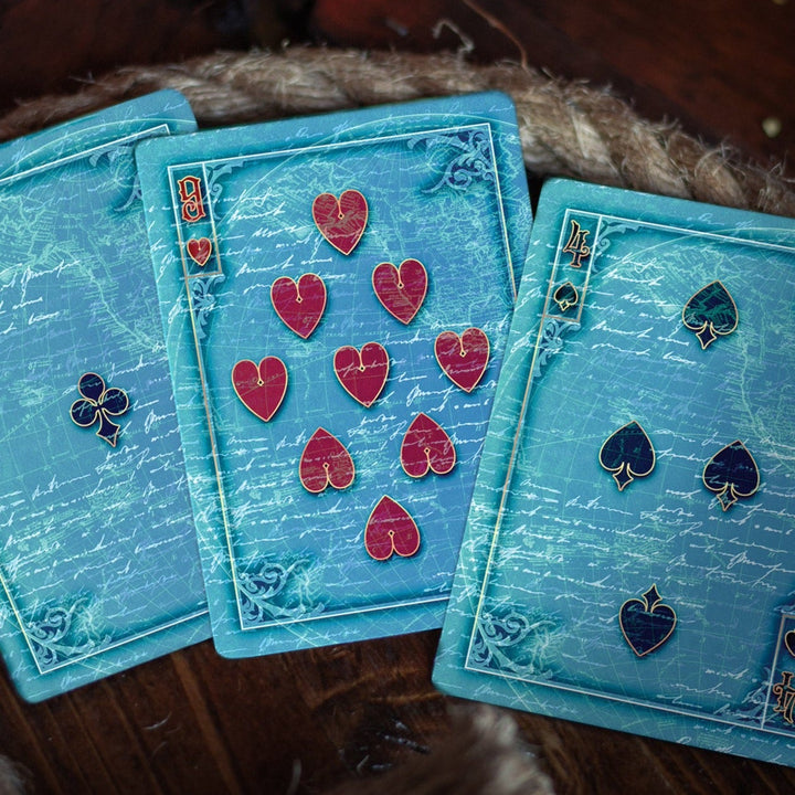 Kraken Signature playing card set featuring artistic heart and spade designs on a blue background