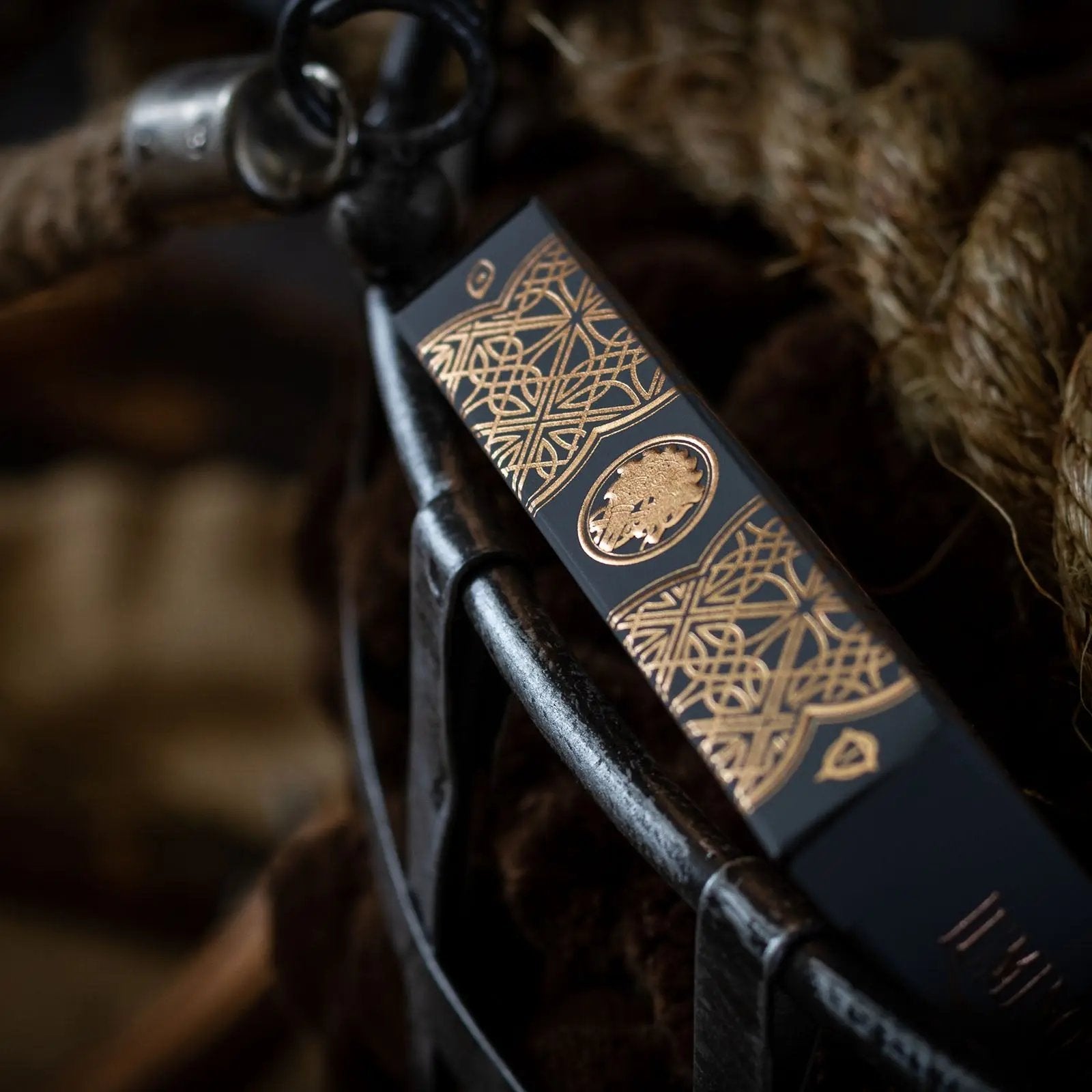 Black Ink Branded Luminosity playing cards with intricate gold artwork on the box design