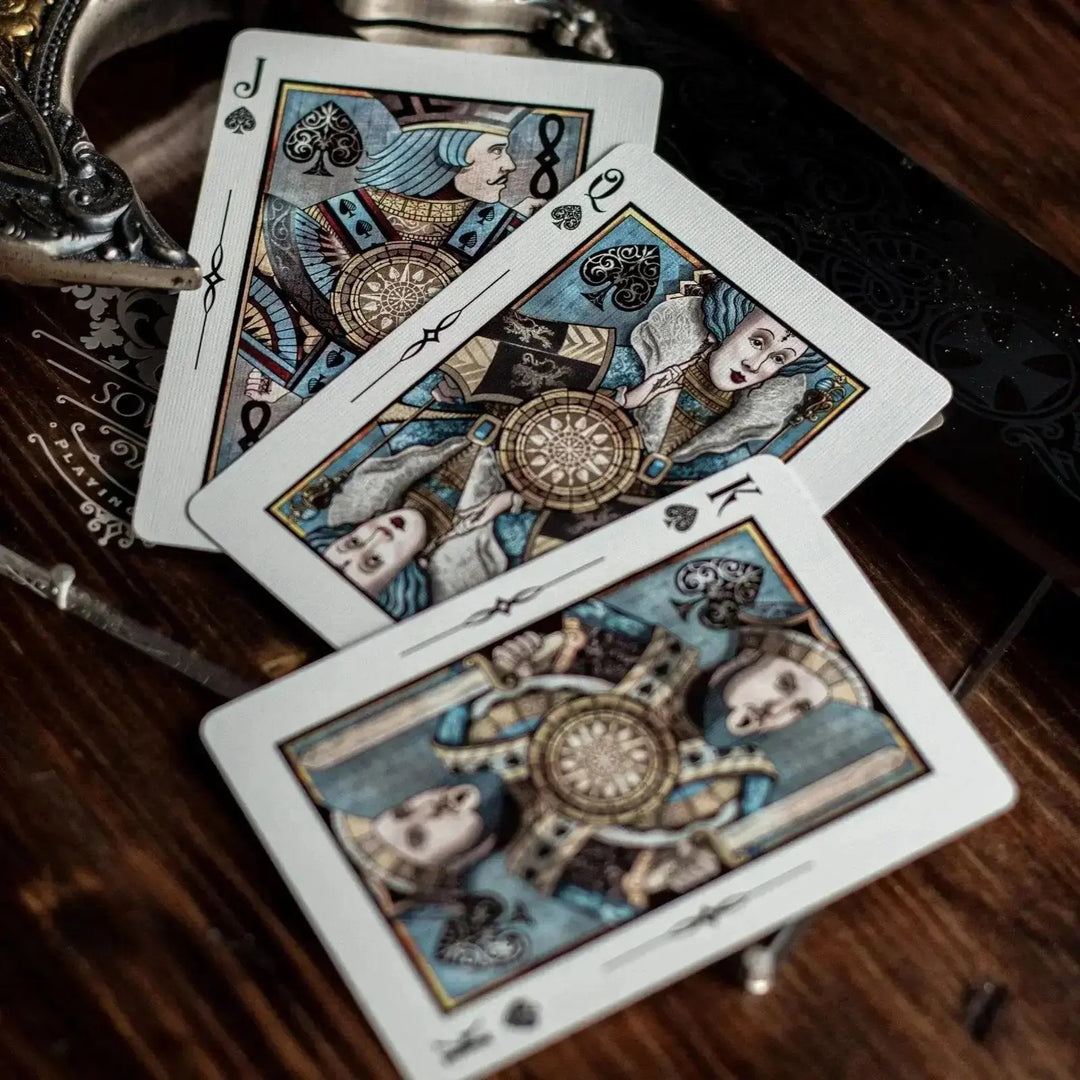 Sovereign luxury playing cards featuring intricate designs and elegant illustrations on a wooden table