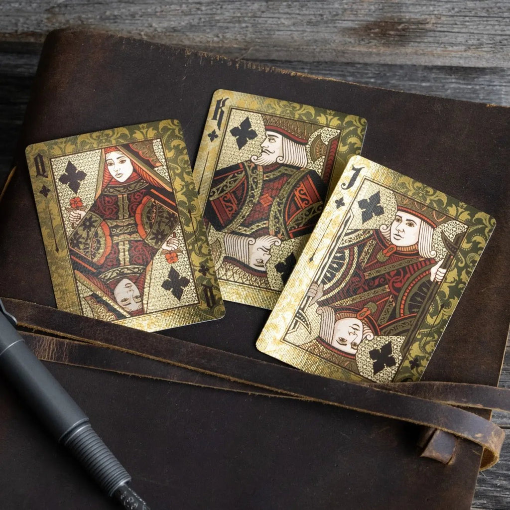 Stone Garden Second Edition playing cards featuring ornate designs of spades on an antique notebook